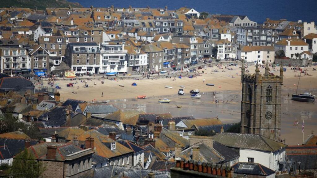 St Ives harbour, Cornwall: this part of England gets the best weather, yet doesn’t get too hot for children. Photograph: Matt Cardy/Getty Images