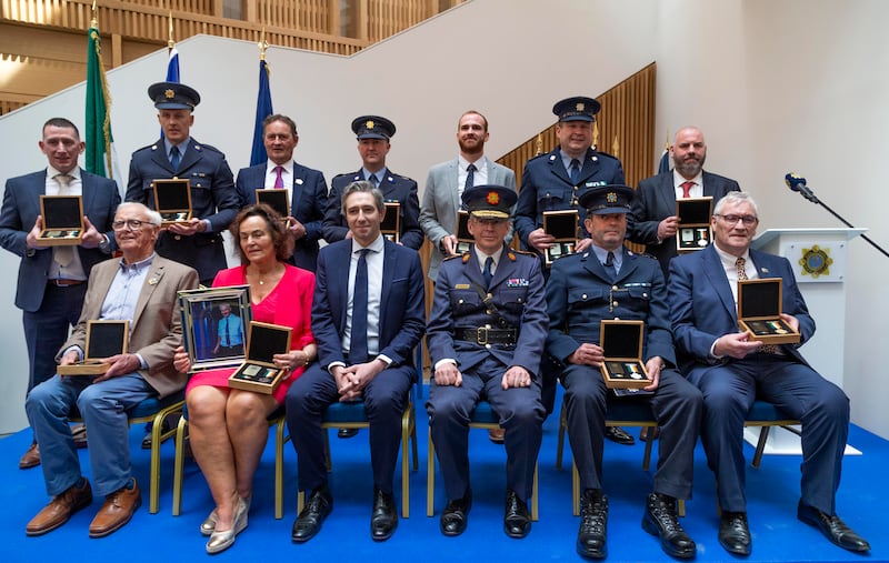 Garda Commissioner Drew Harris and Minister for Justice Simon Harris with the 11 recipients of Scott Medals presented at a ceremony in Dublin on Friday. Photograph: Colin Keegan/Collins Dublin