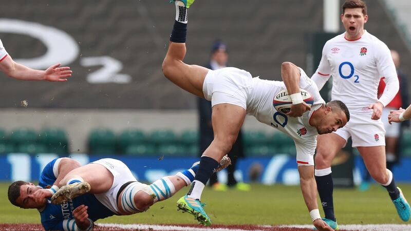 Anthony Watson goes flying after being tackled by Marco Riccioni. Photo: David Rogers/Getty Images
