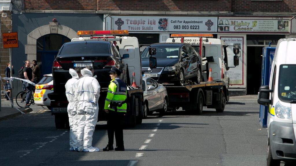 After the shooting in Dublin this morning of Gareth Hutch, two gunmen got into a black BMW car, but it appears not to have started, so they fled on foot. Above, gardaí remove the car from North Cumberland Street this afternoon for technical examination. Photograph: Gareth Chaney/Collins