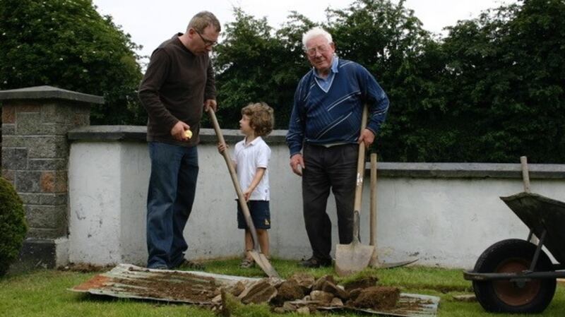 Sean with his son Eoin and father John, digging at their family home in Dundalk.