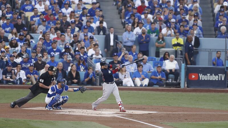 Steve Pearce hits a two-run home run in the top of the first inning of game five of the World Series. Photograph: Larry W Smith/EPA
