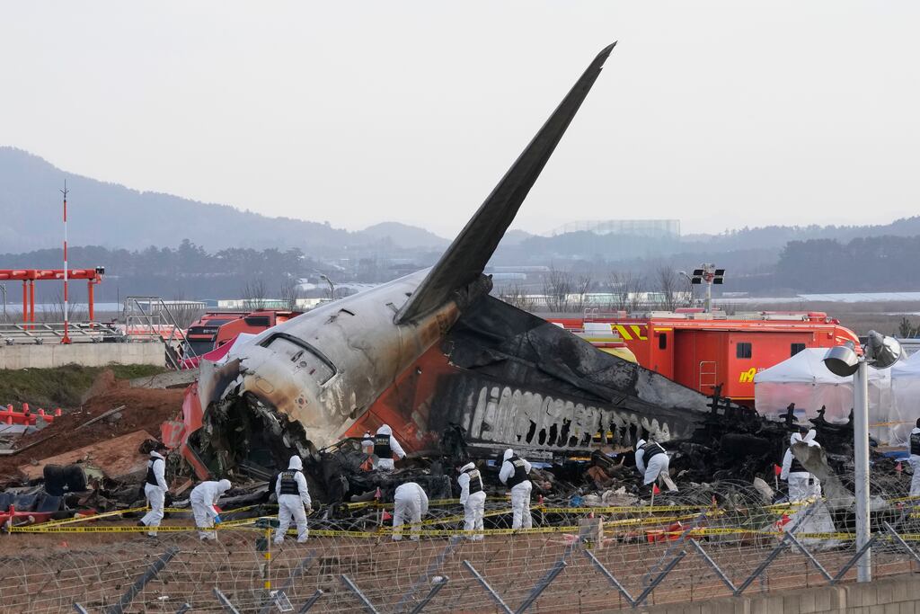 Rescue workers at the site of the Jeju Air crash in Muan, South Korea. Photograph: Ahn Young-joon/AP