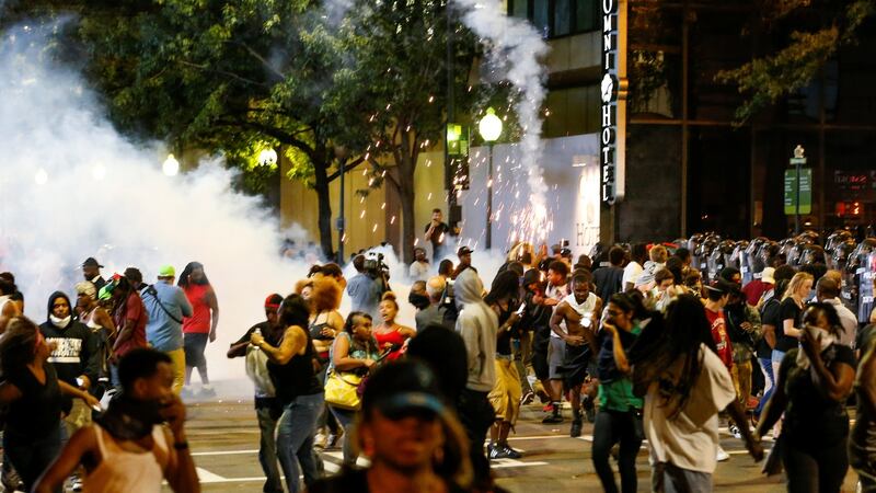 People run from flash-bang grenades in Charlotte, North Carolina during a protest of the police shooting of Keith Scott. Photograph: Jason Micze/Reuters