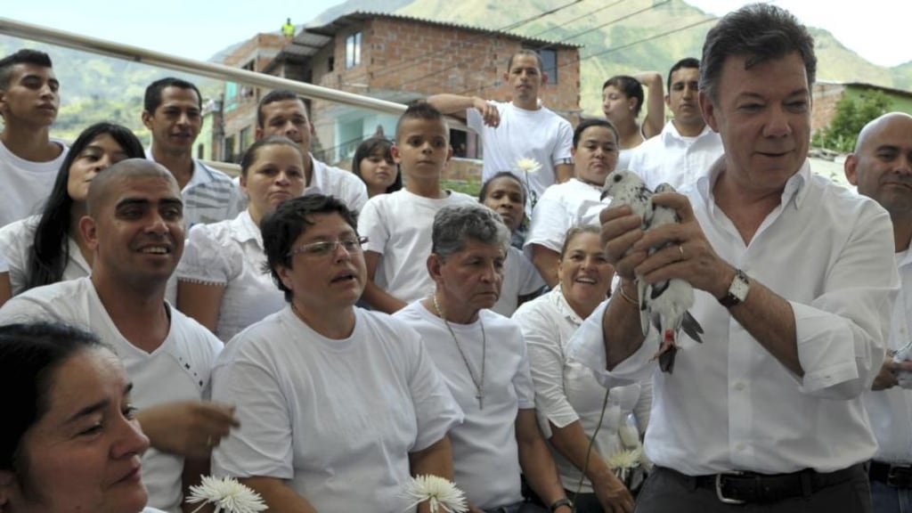 Searching for peace: Colombia’s president, Juan Manuel Santos, holds a pigeon during an official event in Bello Antioquia province in August 2012. Photograph: Javier Casella/ Reuters