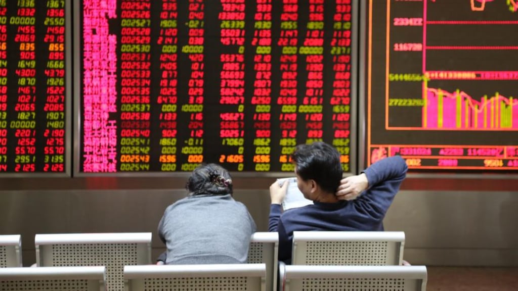 Investors observe the stock market at an exchange hall in Beijing, China. Photograph: ChinaFotoPress/Getty Images