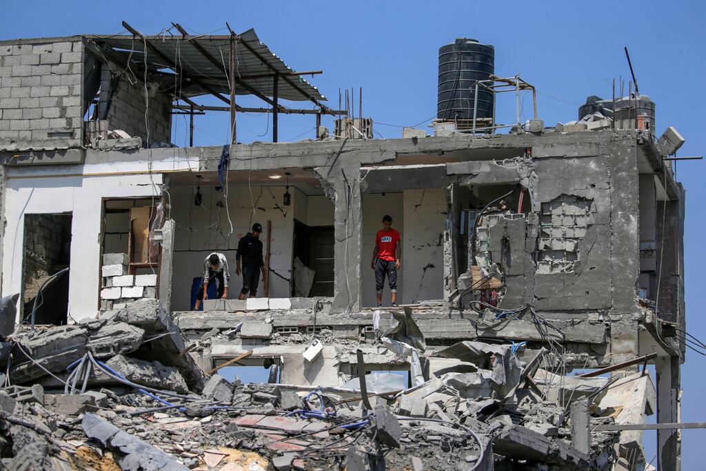 Palestinians inspect their destroyed houses in Al Maghazi refugee camp in central Gaza. Photograph: Mohammed Saber/EPA