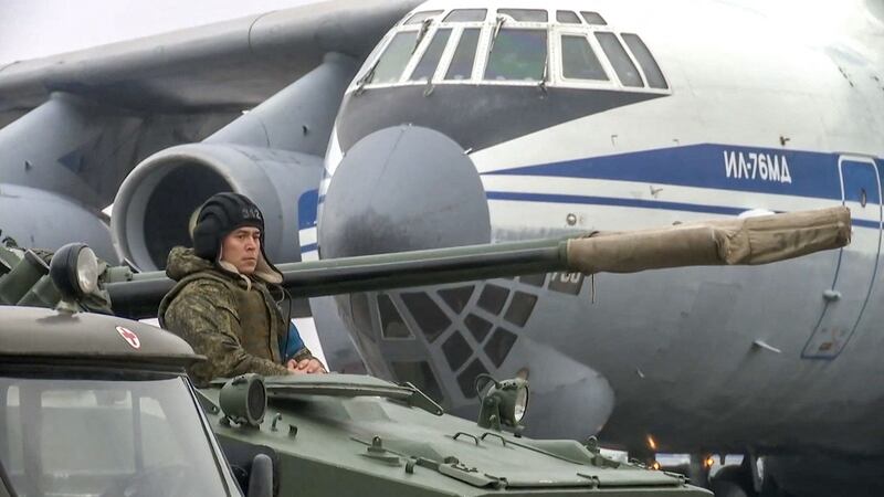 Russian combat vehicle driver waiting at an airfield in Almaty, Kazakhstan. Photograph: Russian defence ministry/AFP via Getty Images
