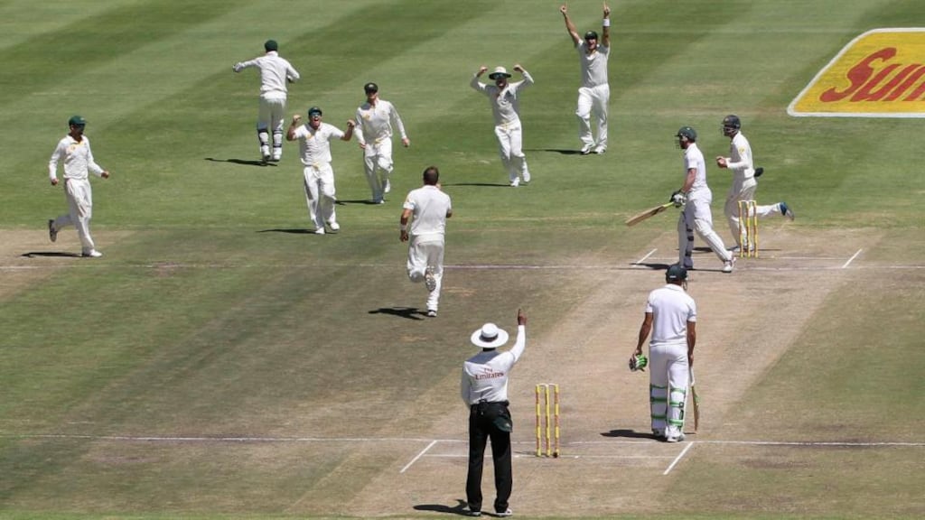 Australian bowler Ryan Harris goes to celebrate with his team-mates after taking the key wicket  of South Africa’s AB de Villiers during the fifth day of the third  Test  at Newlands Stadium in Cape Town. Photograph:  Shaun Roy/Reuters