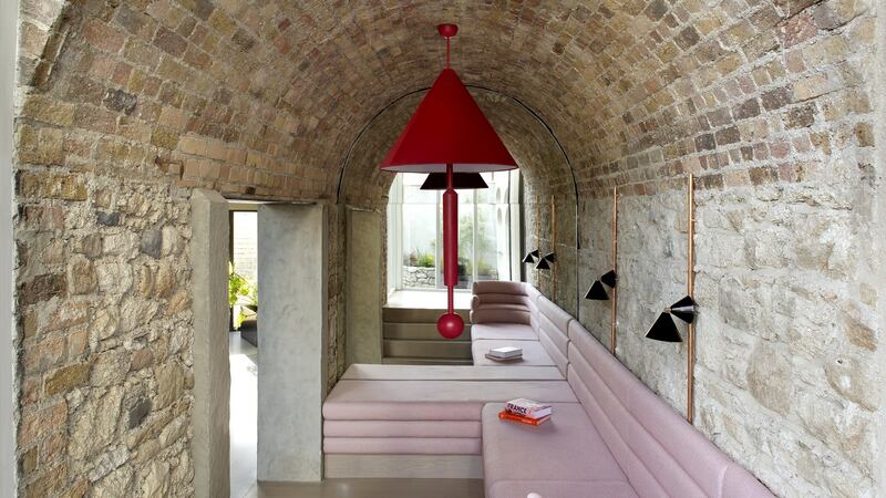 An ultra-feminine, undulating candyfloss-pink sofa. Photograph: Barbara Corsico