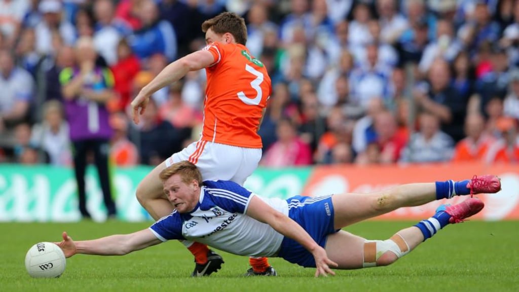 Monaghan’s Kieran Hughes reaches out to get the ball while being challenged by Armagh’s Charlie Vernon during the Ulster SFC semi-final at St Tiernach’s Park in Clones. Photograph: Cathal Noonan/Inpho