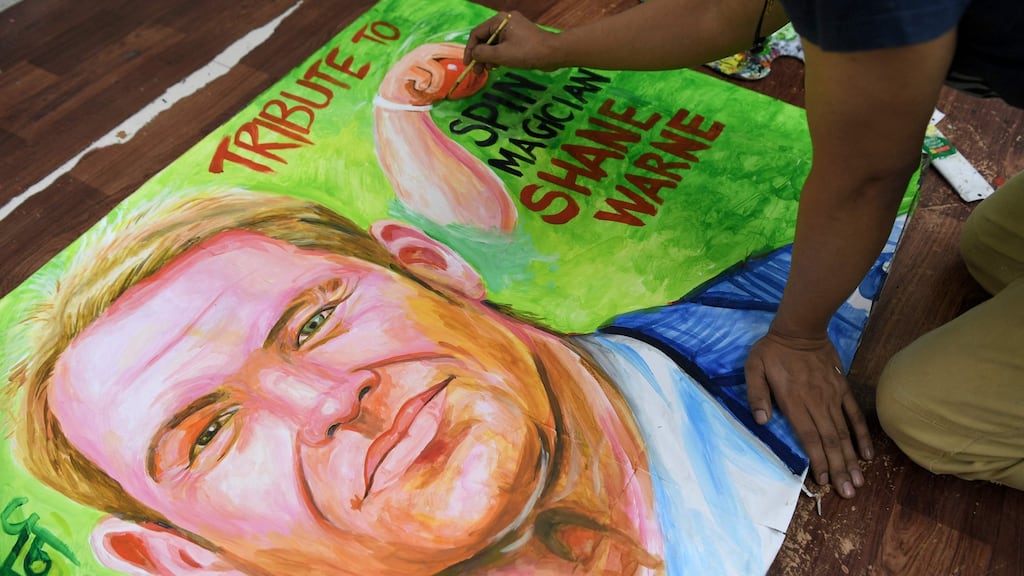 An art school teacher makes a painting to pay homage to the former Australian cricketer Shane Warne in Mumbai. Photograph: Indranil Mukherjee/AFP via Getty Images