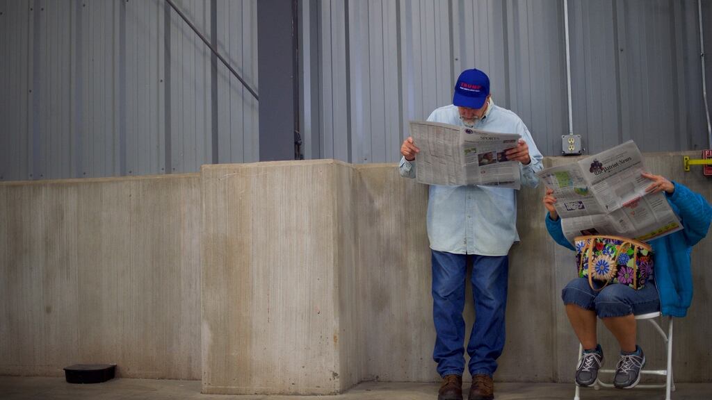 Swinging the balance? Supporters of Donald Trump read a newspaper before the start of a campaign event in York, Pennsylvania, on Thursday. Photograph: Mark Makela/The New York Times