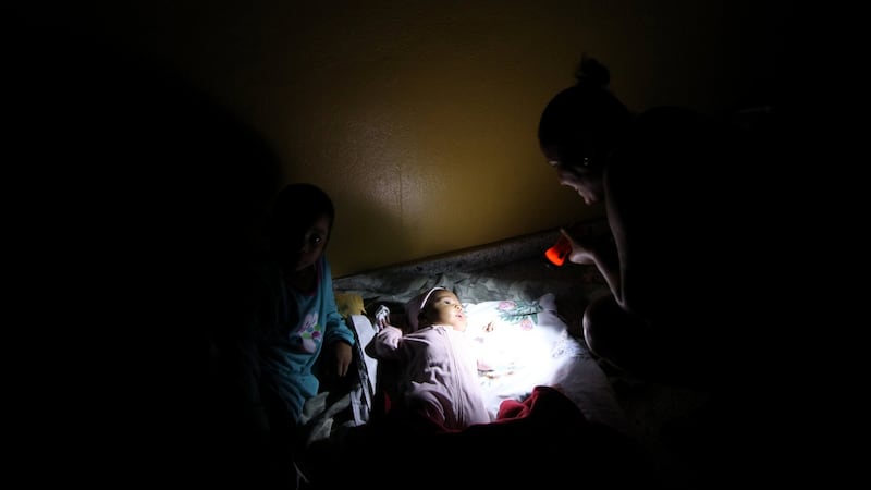 A woman with a flashlight illuminates her baby inside a shelter before the arrival of the Hurricane Maria in Punta Cana. Photograph: Reuters/Ricardo Rojas