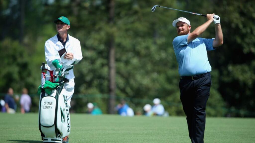 Shane Lowry hits an approach shot as his caddie looks on during a practice round prior to the start of the 2015 Masters Tournament at Augusta National. Photo: Andrew Redington/Getty Images