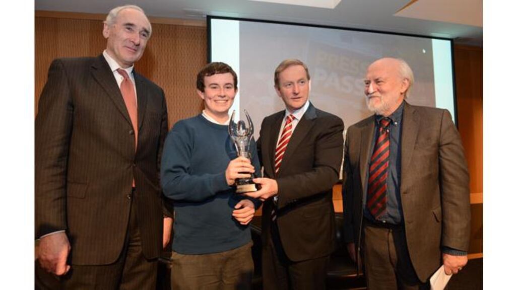 Taoiseach Enda Kenny presents Fiachra O'Braonain with his award. Also pictured are Matt Dempsey, NNI chairman (l) and Prof John Horgan, chairman of the judging panel. Photograph: Dara Mac Donaill/The Irish Times