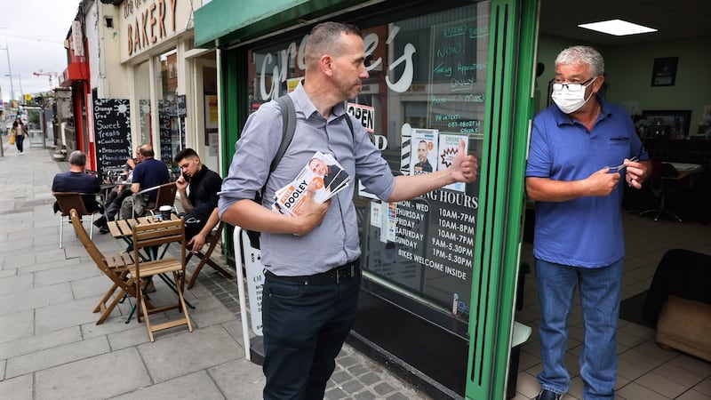 Peter Dooley, Independent meets supporters Tony Greene at Greenes Barber Shop, while out canvassing in Rathmines. Photograph: Dara Mac Donaill / The Irish Times