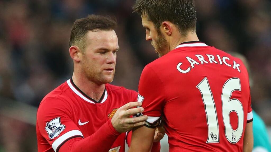 Wayne Rooney passes the captain’s armband to Michael Carrick during last weekend’s match between Manchester United and Liverpool at Old Trafford. Photograph: Alex Livesey/Getty Images