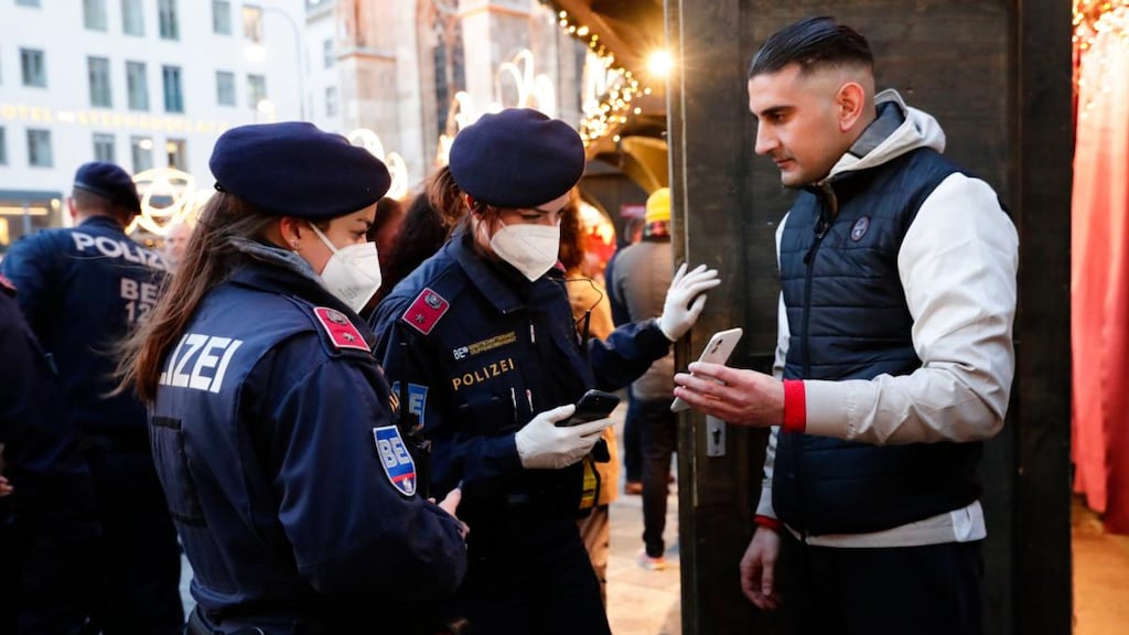 Police officers check the vaccination status of visitors during at a Christmas market in Vienna on Friday. Photograph: Lisa Leutner/AP