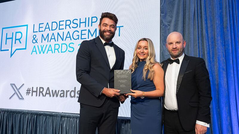 Aricio Silvestre, awards judge, presents the best private sector HR initiative award to Grainne Kennedy, Baxterstory