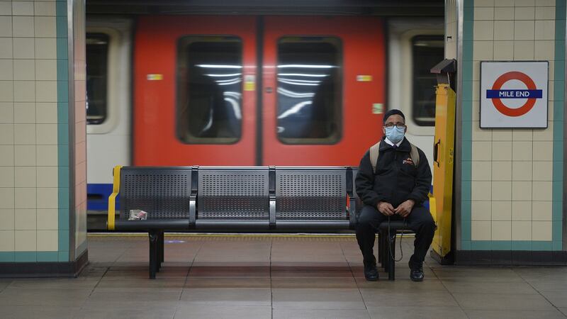 A man wears a face mask as he waits for a train at Mile End underground station, following the announcement that wearing a face covering will be mandatory for passengers on public transport in England from June 15th. Photograph: Nick Ansell/PA
