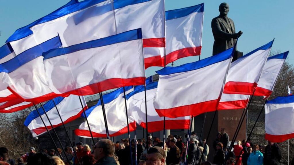 People attend a rally in front of Crimean flags at Lenin Square in Simferopol, Crimea today. The Moscow-leaning Crimea region is due to hold a referendum tomorrow on whether to break away from Ukraine and join Russia, with observers fearing worsening violence on the peninsula ahead of the vote. Photograph: Yuri Kochetkov/EPA