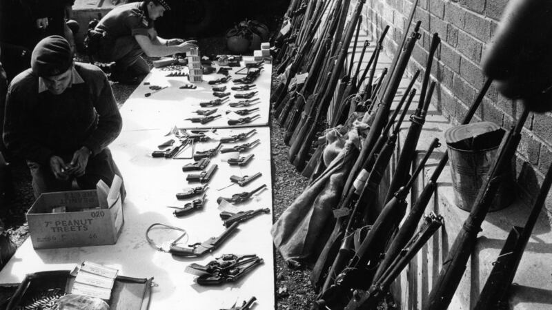 July 1970: British soldiers sort through a weapons cache in Belfast. Photograph: Malcolm Stroud/Express/Getty Images