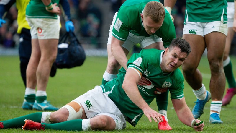 Johnny Sexton is helped to his feet by Keith Earls after his tackle on Hadleigh Parks. Photo: Tom Honan/The Irish Times.