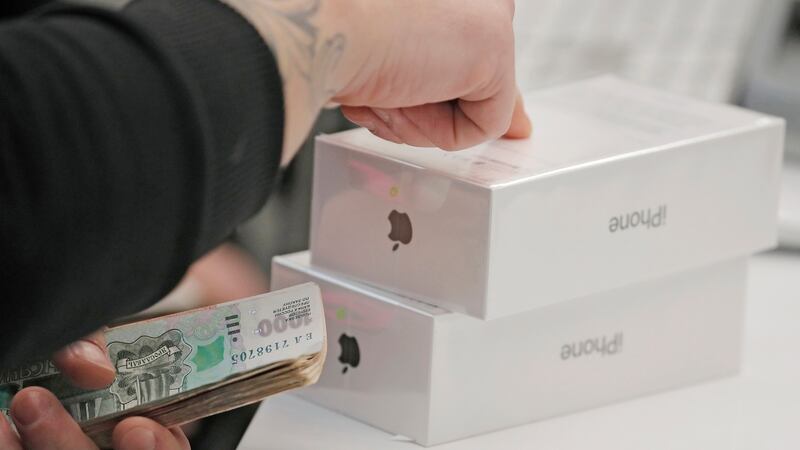 An Apple staff member counts a customer’s money as they pay for a new iPhone X at an Apple shop during its launch in Moscow, Russia, on November 3rd, 2017. Photograph: Sergei Ilnitsky.