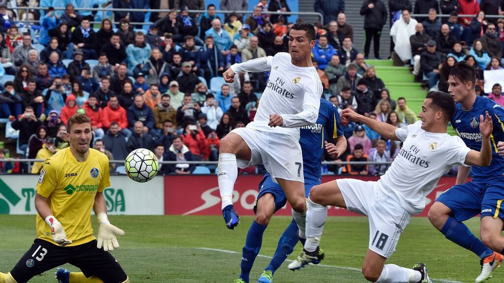 Real Madrid’s Cristiano Ronaldo (C) vies with Getafe’s goalkeeper Vicente Guaita (L) next to Madrid midfielder Lucas Vazquez (2nd R) Photograph: Gerard Julien/AFP/Getty Images