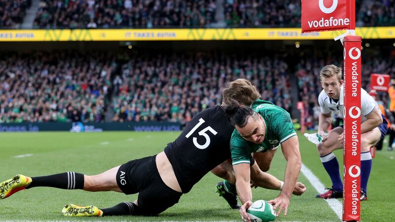 Ireland’s James Lowe scores the first try of the game despite the challenge of New Zealand fullback Jordie Barrett during the autumn international at the Aviva Stadium. Photograph: Dan Sheridan/Inpho
