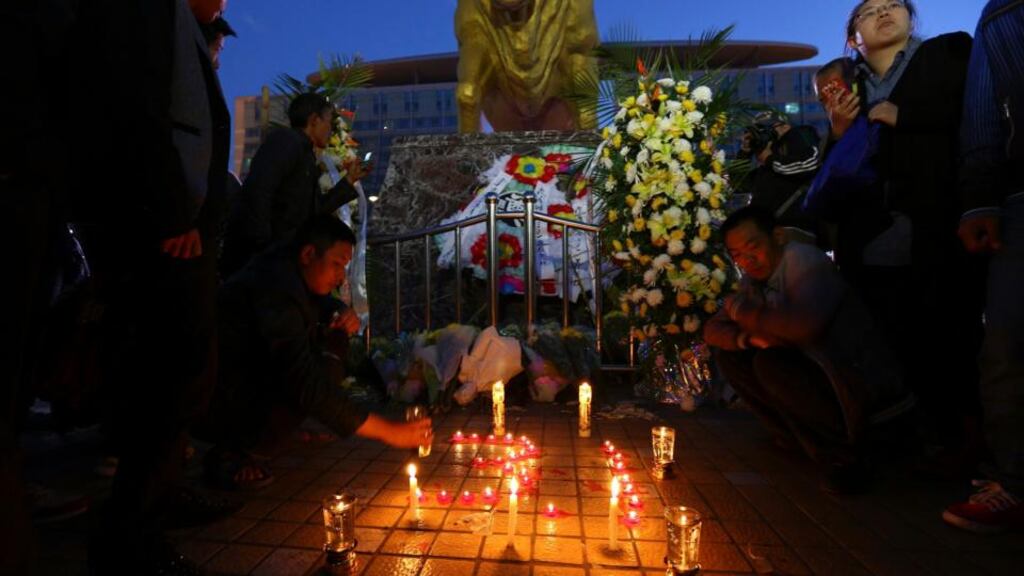 People light candles outside Kunming railway station after 29 people were hacked to death  in an attack. Photograph: Wong Campion/Reuters