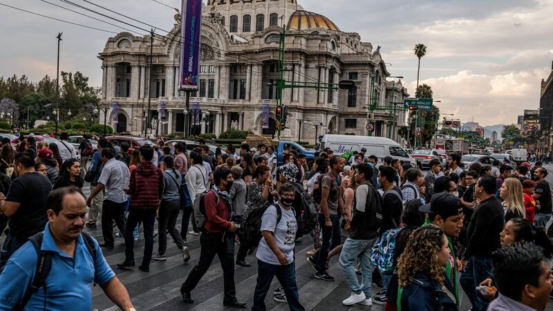 Pedestrians at a busy intersection by the Palacio Bellas Artes in Mexico City. Photograph: Victor Moriyama/The New York Times