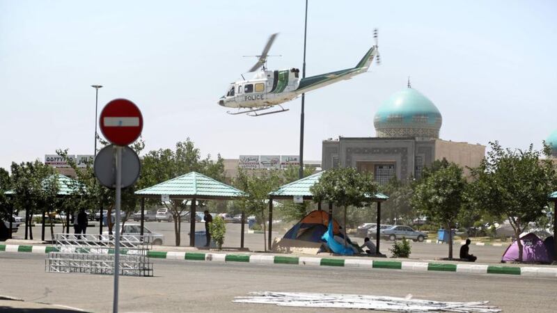 A  police helicopter near the mausoleum of Ayatollah Ruhollah Khomeini in Tehran, Iran, after it was attacked on Wednesday. Photograph: Hasan Shirvani/AFP/Getty Images