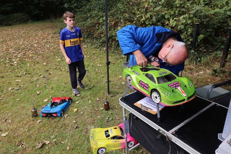 Race controller Denis Fox check all cars after they race
