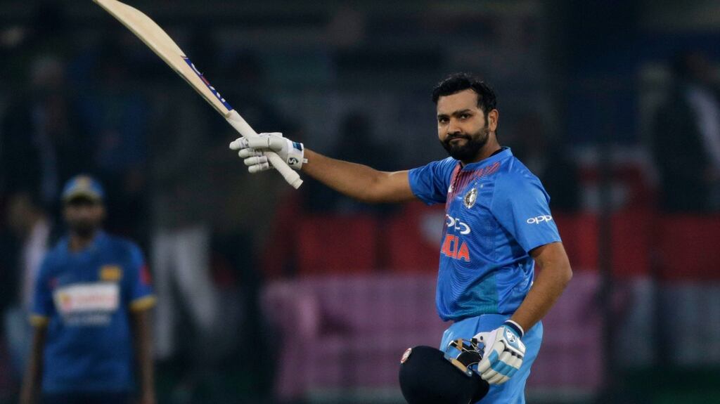 India’s captain Rohit Sharma raises his bat to celebrate scoring a century during their second Twenty20 international cricket match against Sri Lanka in Indore, India. Photograph: Rajanish Kakade/AP