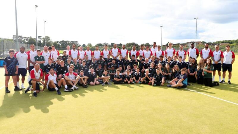 The England players and coach Eddie Jones pose for a group photo with children from Blaise High School in Bristol, England. Photograph: Dan Mullan/Getty