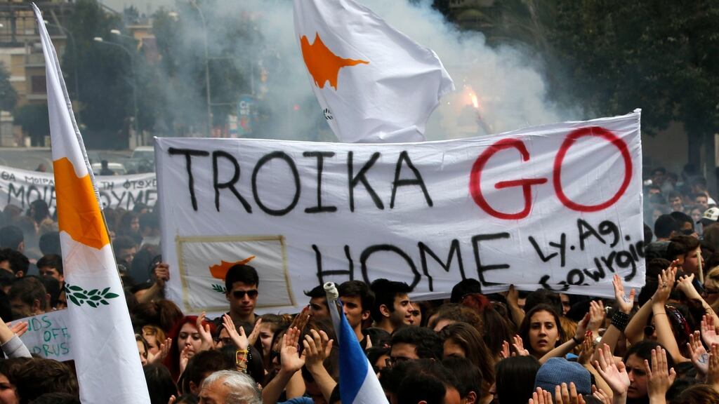 Students take part in an anti-Troika protest outside the Presidential palace in Nicosia. Cyprus's Stock Exchange extended an almost two-week shutdown after the island placed controls on currency transactions to prevent a run on deposits when banks reopen. Photograph: Yannis Behrakis/Reuters