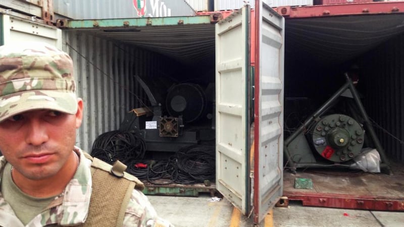 A soldier stands near two containers holding arms seized from the North Korean flagged ship Chong Chon Gang at the Manzanillo Container Terminal in Colon City yesterday. Photograph: Carlos Jasso/Reuters