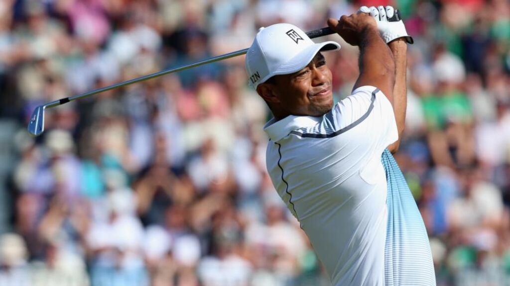 Tiger Woods tees off on the fourth hole during the first round of the 143rd Open Championship at Royal Liverpool in Hoylake. Woods signed for a solid 69. Photograph: Andrew Redington/Getty Images