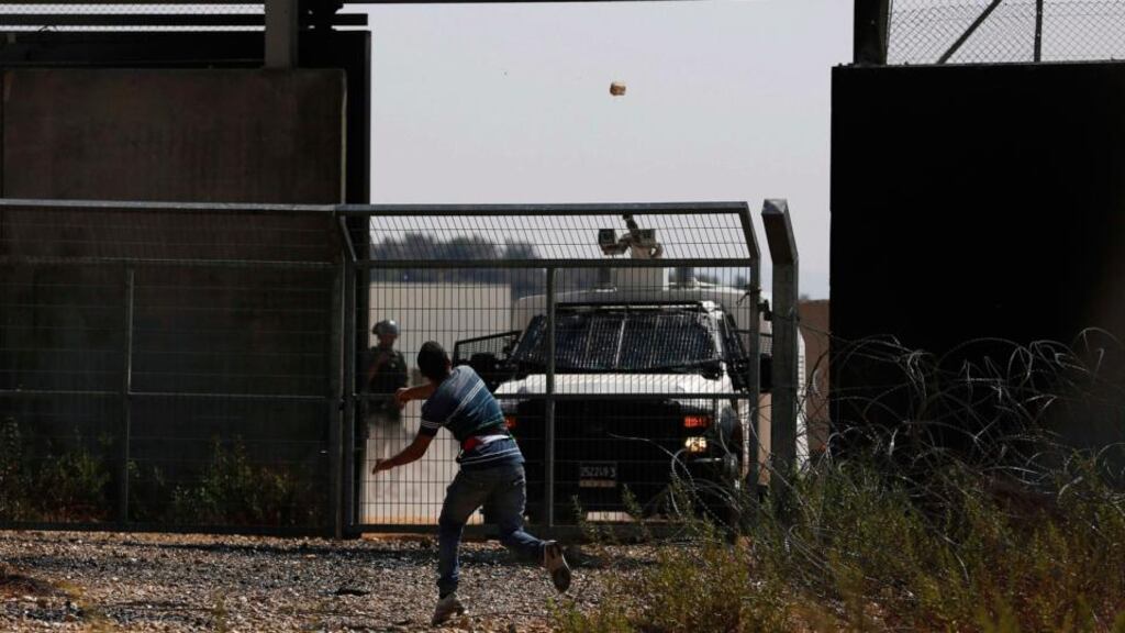 A Palestinian protester hurls a stone at Israeli troops during clashes after a protest, which was against Palestinian prisoners being held in Israeli jails, in the West Bank village of Bilin near Ramallah. Photograph: Mohamad Torokman/Reuters