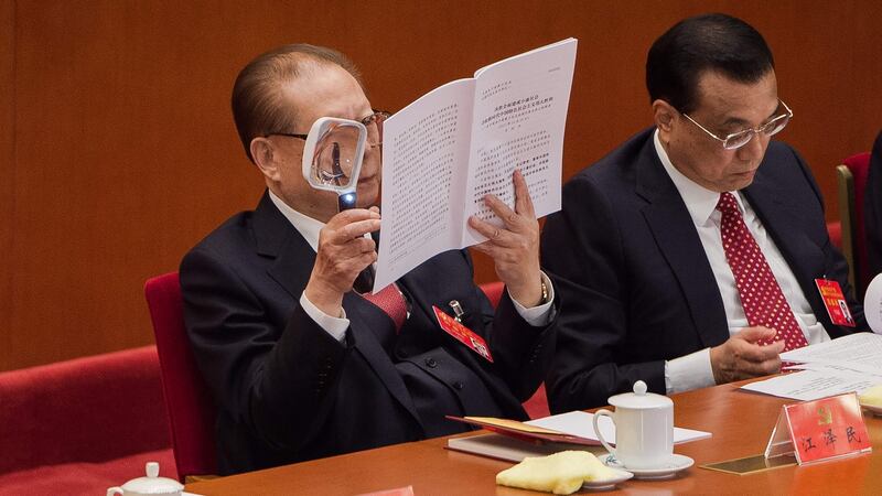 China’s former president Jiang Zemin reads Xi Jinping’s speech with a magnifying glass. Photograph: Nicolas Asfouri/AFP/Getty Images