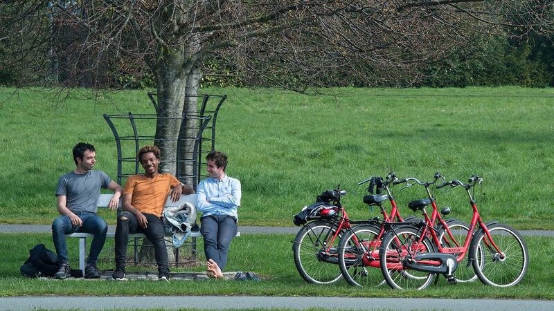 French tourists Bruno Jonathan, Julien Gossec and Nikias Ioannidis enjoy the sunshine in the Phoenix Park, Dublin, on Good Friday, the hottest day of the year so far. Photograph: Dave Meehan/The Irish Times