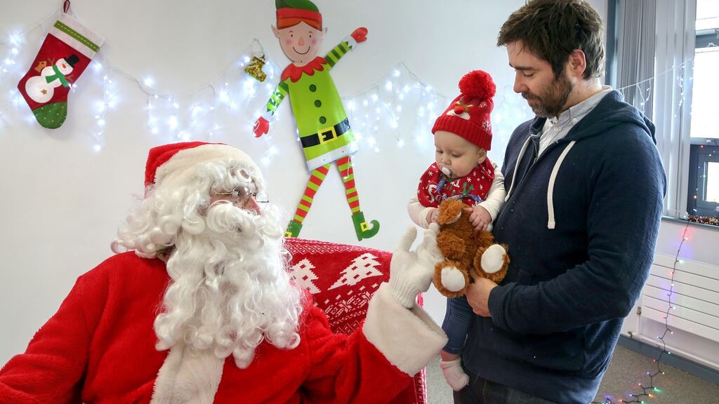Freya Hennessy (9 months) and her father, Michael, from Knocknacarra, Galway, meet Santa at the sensory-friendly grotto at the NUIG school of psychology. Photograph: Joe O’Shaughnessy