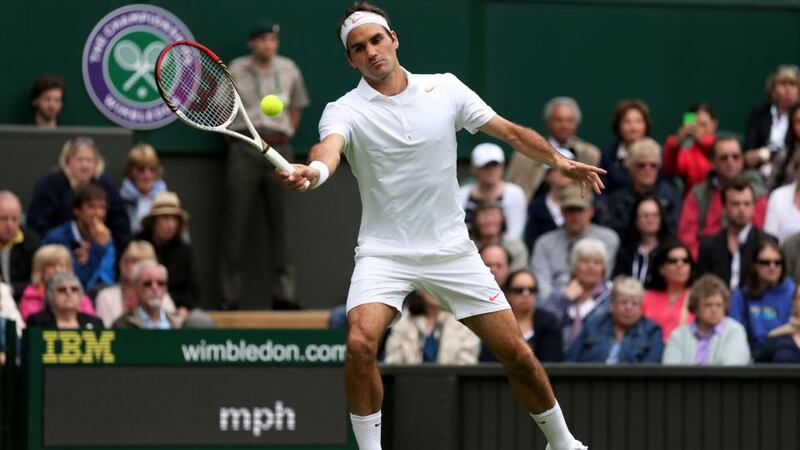 Roger Federer plays a forehand during his singles first round match against Victor Hanescu on day one of Wimbledon. Photograph: Clive Brunskill/Getty Images