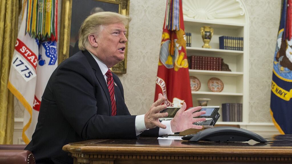 US president Donald Trump addresses US armed forces members on a Christmas Day video conference call in the Oval Office at the White House in Washington . Photographer: Zach Gibson/Bloomberg