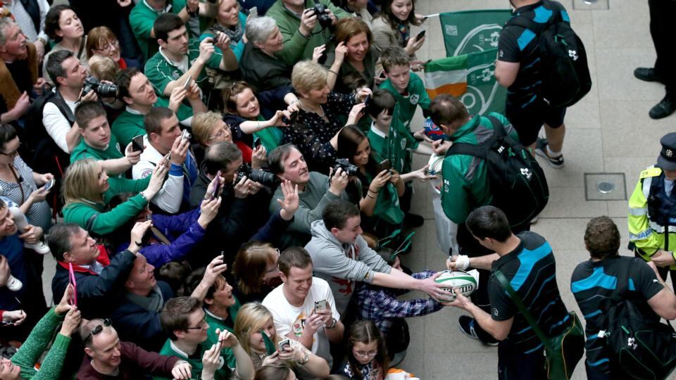 Players sign autographs for fans as they arrive into Dublin Airport this afternoon. Photograph: Ryan Byrne/Inpho