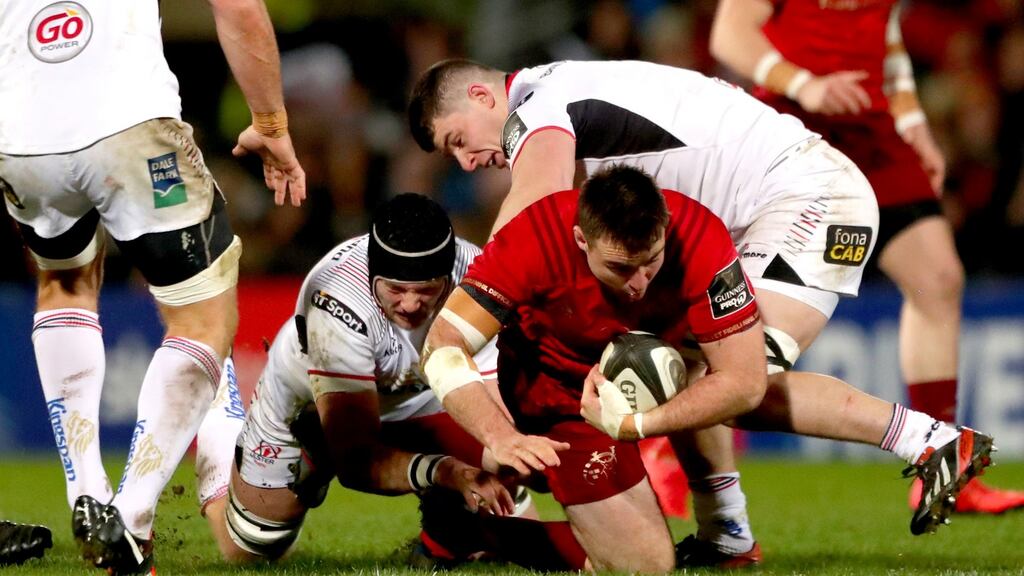 Ulster’s Kieran Treadwell and Nick Timoney tackle Niall Scannell on New Year’s Day. Photograph: James Crombie/Inpho