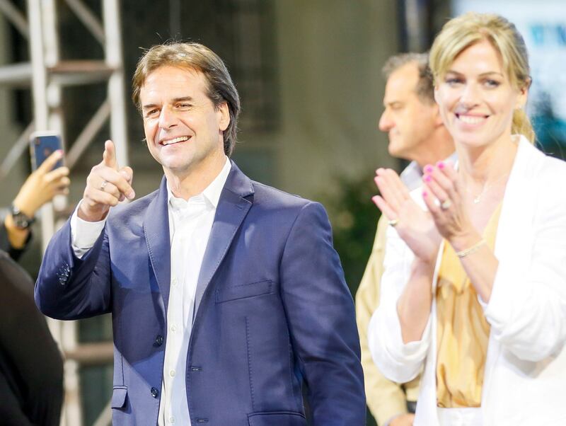 Luis Lacalle Pou and his wife Lorena Ponce de Leon acknowledge his supporters after the second-round presidential elections, in Montevideo, Uruguay on Monday. Photograph: Mariana Greif/Reuters