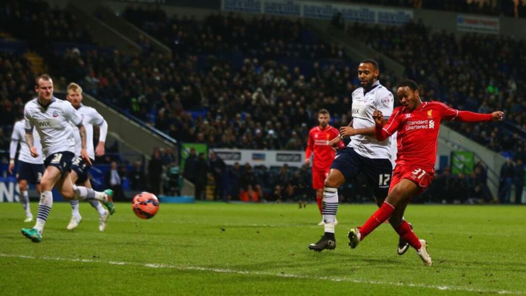 Liverpool’s Raheem Sterling scores his side’s equaliser in the FA Cup fourth-round replay against Bolton Wanderers at Macron Stadium. Photograph: Michael Steele/Getty Images